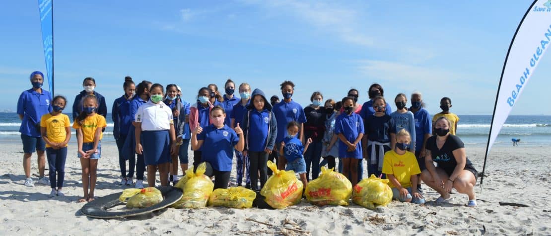 group of people at a beach cleanup with Save a Fishie