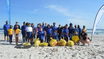 group of people at a beach cleanup with Save a Fishie