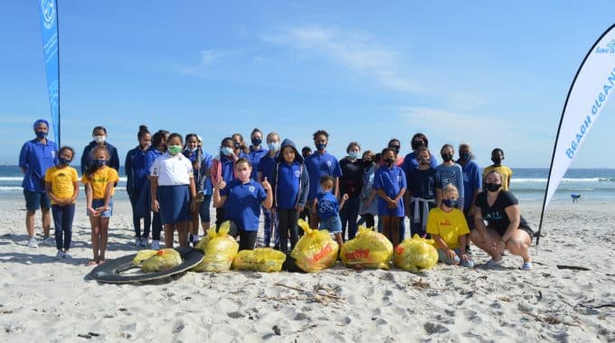 group of people at a beach cleanup with Save a Fishie