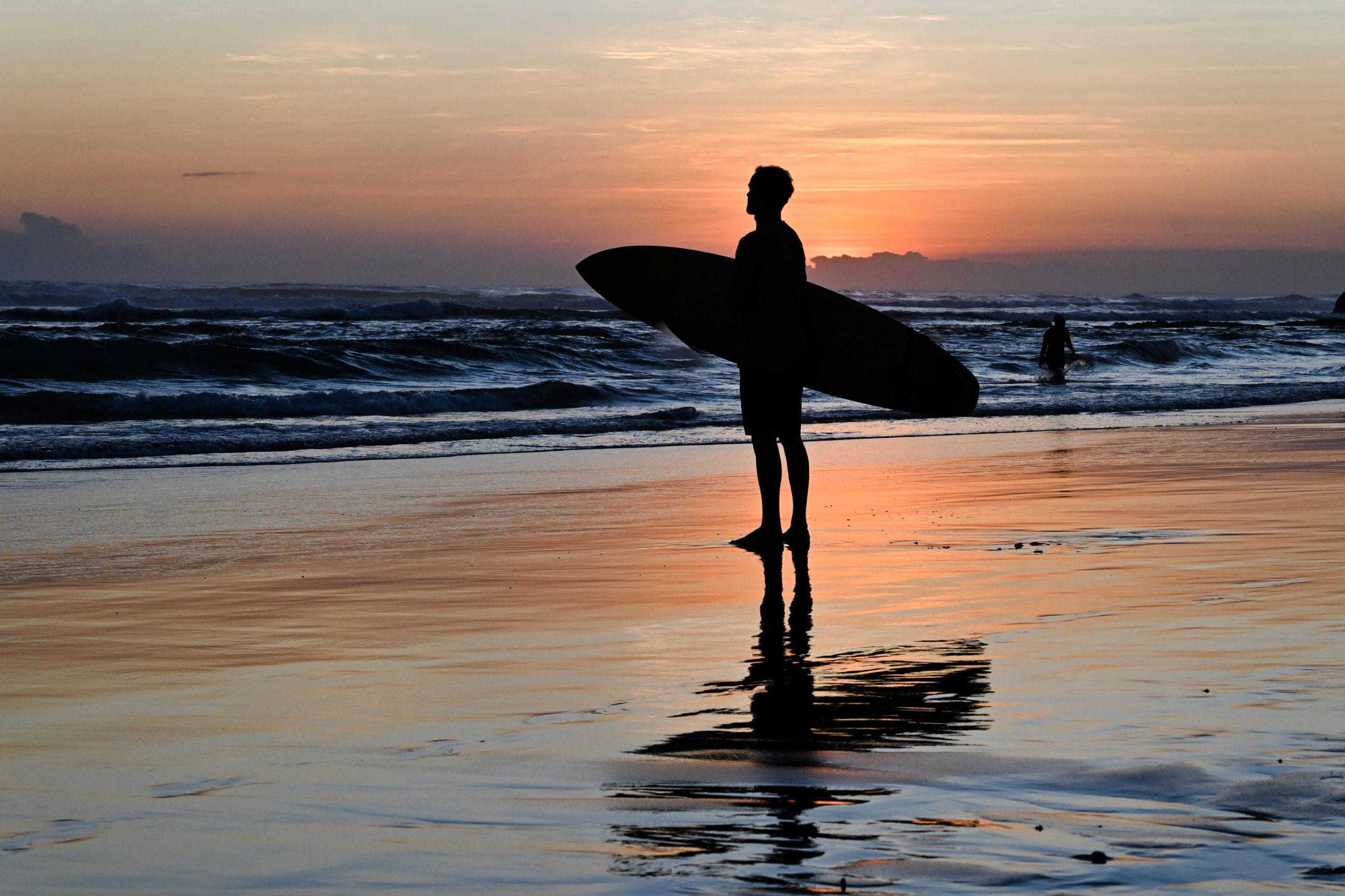 Silhouette of a surfer on a beach in Canggu, Bali