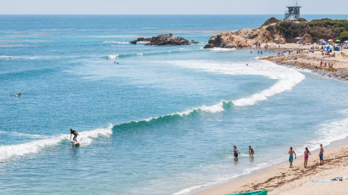 Surfers, swimmers and sunbathers enjoying a summer day in southern California.